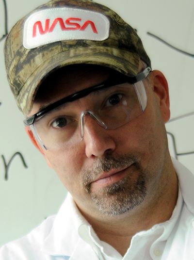 A man wearing glasses and a hat